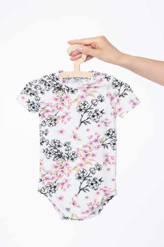 Body neonato Milk & Love fiori chiari cotone manica corta